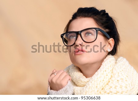 Pensive young women with thick-rimmed glasses