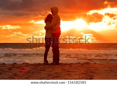 Couple Man and Woman Hugging in Love staying on Beach seaside with Sunset scenery People Romantic relationship and Friendship concept