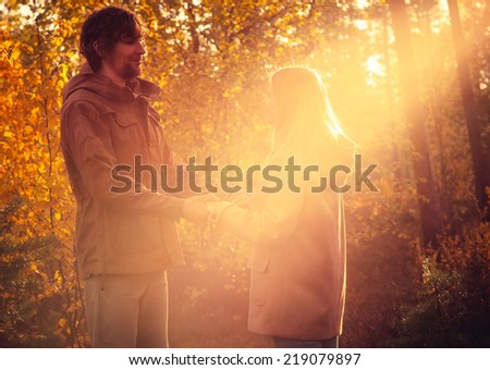 Young Couple Man and Woman Hugging in Love Romantic Outdoor with sun light Autumn nature on background Fashion trendy style