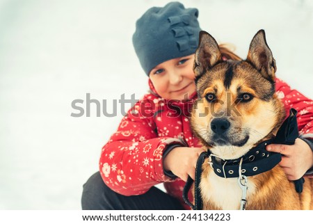 Girl Child and Dog hugging and playing Outdoor Lifestyle Friendship concept Winter nature on background