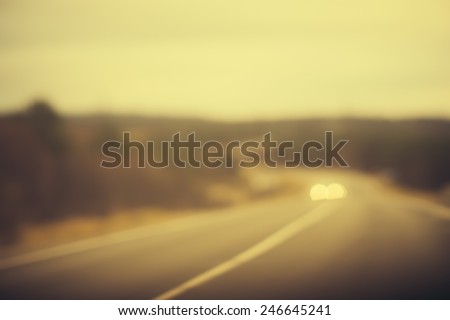 Road track and Cars headlights Background Blurred Travel concept retro film colors