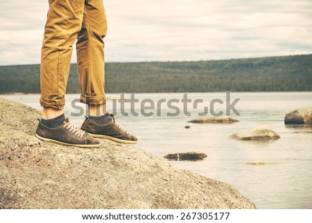 Feet Man walking Outdoor Travel Fashion Lifestyle nature on background retro colors
