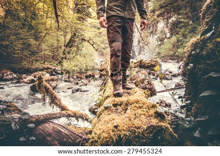 Feet Man hiking outdoor with river and forest on background Lifestyle Travel survival concept