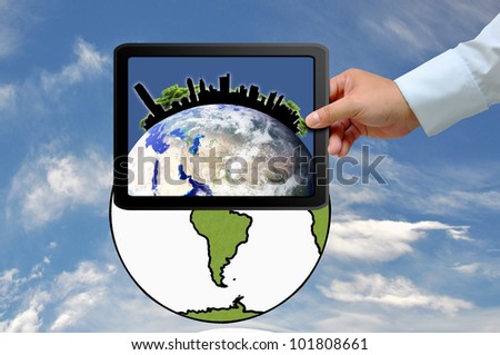 Hand holding tablet PC with city on earth globe