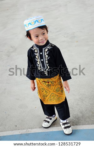 Portrait of asian boy with smile in malaysia dress