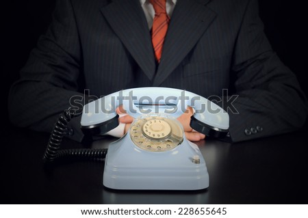 Businessman is waiting for Important call on the black background