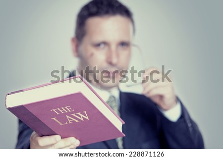 lawyer holding a red book, law and justice concept.