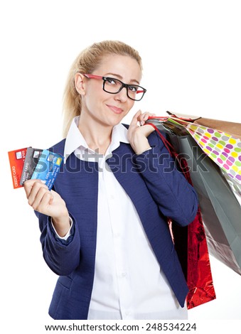 Businesswoman holding credit cards with shopping bags on white background