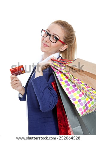 Businesswoman holding credit card with shopping bags on white background