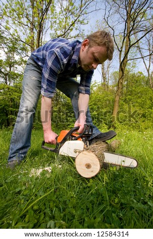 Young man cutting wood