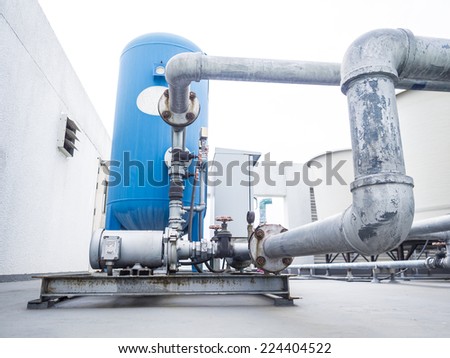 water pump and compressor tank connected with pipeline on the roof