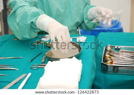 Nurse with operating tools and chest implants