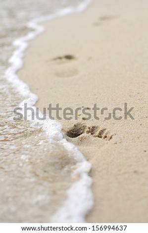 Human footprints on the sand beach