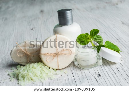 Bars of soap with fresh mint leaves, salt bath and face cream
