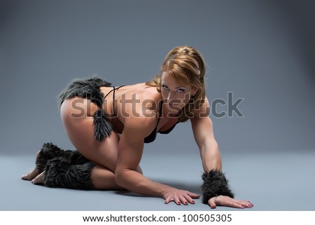 Strong woman body builder in amazon fur costume