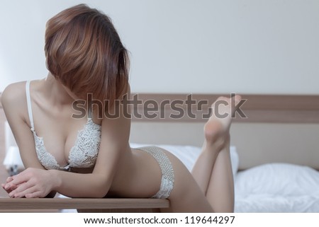 Beautiful and sexy woman in bedroom