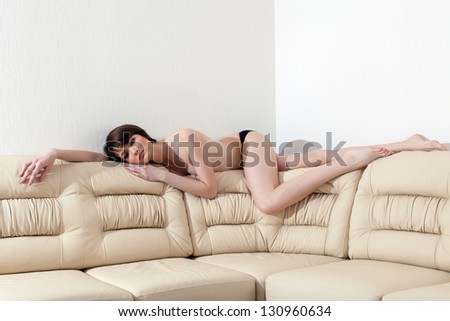 Slim beautiful woman laying on sofa
