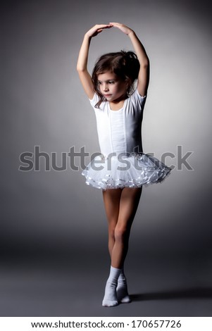 Graceful little gymnast performs in studio