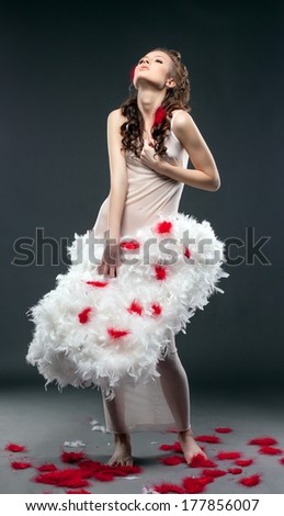 Cute curly woman posing with angel wings
