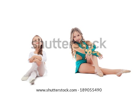 Two adorable young gymnasts posing in studio