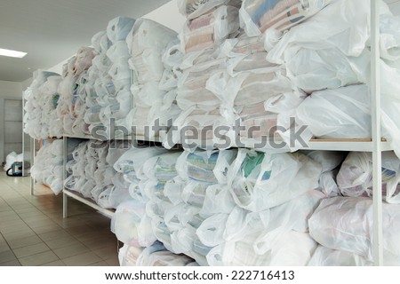 Racks with clean linen in laundry room