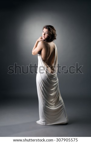 Rear view of sexy girl in loose-fitting dress