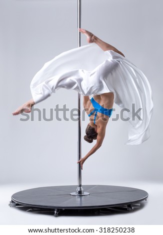 Sexy dancer hanging upside down on pole