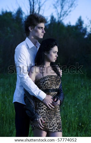 young couple on nature background - love scene