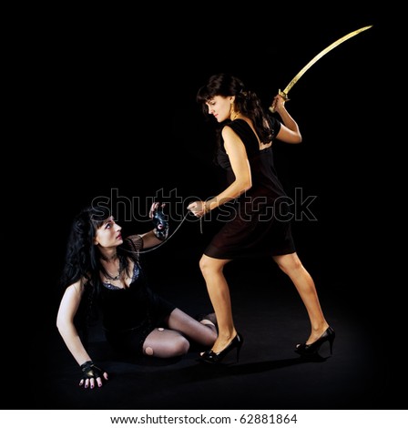 Two woman fight with sword on dark