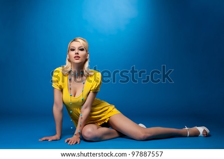 Beauty pinup woman in sexy yellow cloth