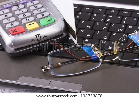 Business still-life of tables, payment terminal, credit Cards, notebook, eyeglasses