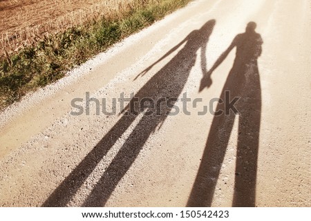 Shadows of couple in love on a walk.