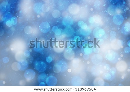 Abstract blurred blue color bokeh with snowfall or rainfall background. Beautiful freshness snowy New Year and Christmas background with copy space background.