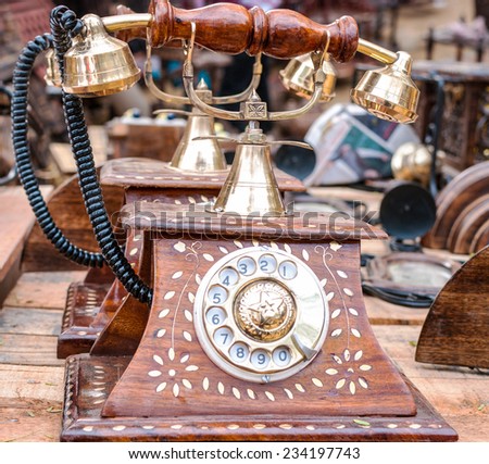 An old telephone standing on a table