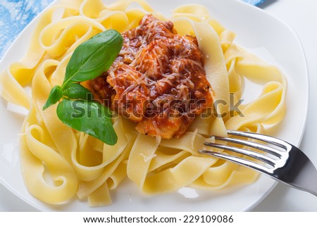 Tagliatelle pasta with meat bolognese sauce and cheese. Italian cuisine.