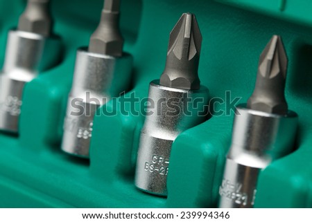 Set of tools closeup (cruciform wrench heads in green plastic case)