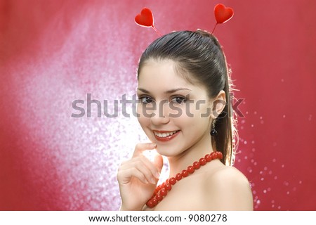young smiling female with two hearts on her head