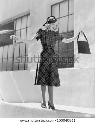 Woman balancing on edge of wall