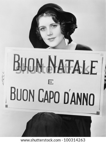 Woman holding sign written in Italian