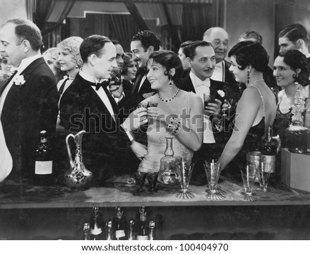 Couple having drink at crowded bar