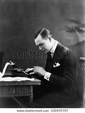 Portrait of man using typewriter