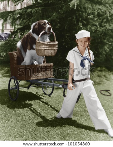 Girl in sailor suit pulling dog in basket