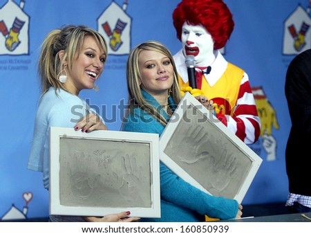 Haylie and Hilary Duff hold handprints off themselves at the MCDONALD\'S WORLD CHILDREN\'S DAY KICK OFF in Los Angeles, California, November 9, 2004