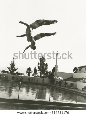 Synchronized divers in mid-air 商業照片 © 