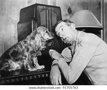 Man and dog listening to the radio