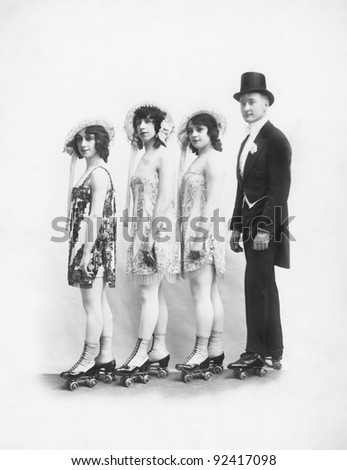 Four people on roller-skates standing in a line