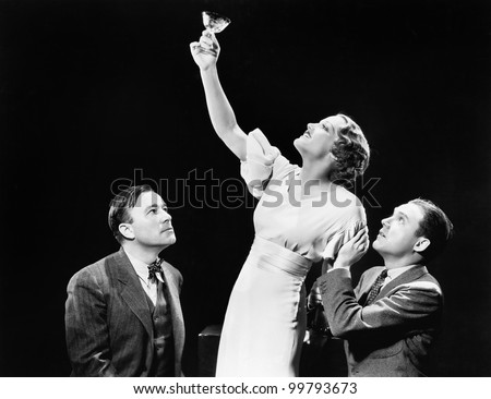 Two men supporting  a woman lifting her wine glass