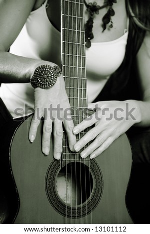Female Hands Holding a Country Western Guitar
