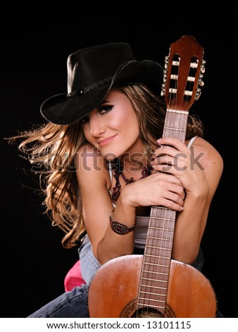 Beautiful Woman in Country Western Fashion Holing A Guitar