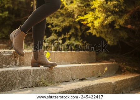 Similar – Image, Stock Photo Woman in brown boots standing on a wooden floor holding a dried artichoke flower in her hand